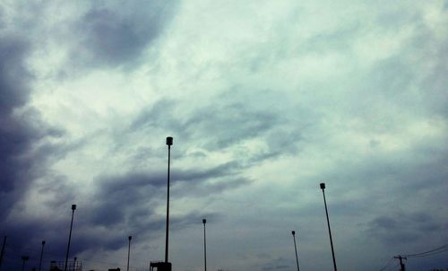 Low angle view of street light against cloudy sky