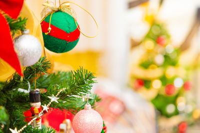 Close-up of christmas decorations hanging on tree