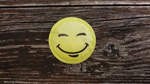 Close-up of smiley face on wood