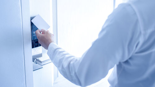 Midsection of man working with mobile phone