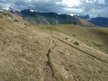 Scenic view of mountains against cloudy sky