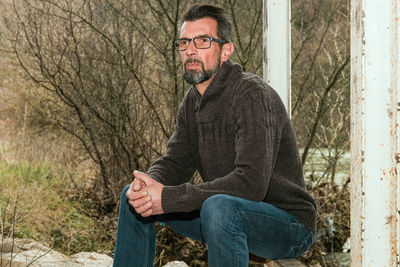 Midsection of man sitting in park