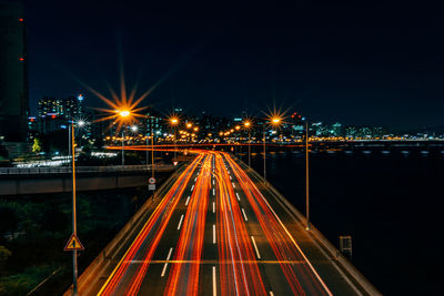 Light trails on road in city at night