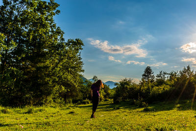 Man standing on field against sky