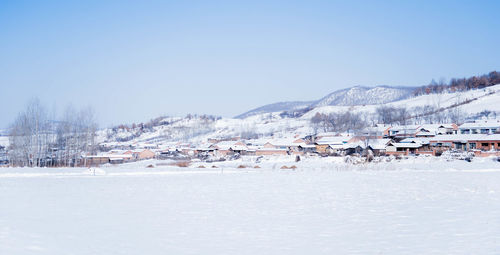 Scenic view of snow covered mountains against clear sky