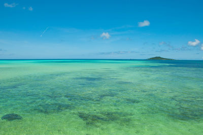 Scenic view of sea against blue sky