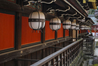 Low angle view of lanterns hanging by building