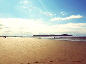 View of beach against cloudy sky