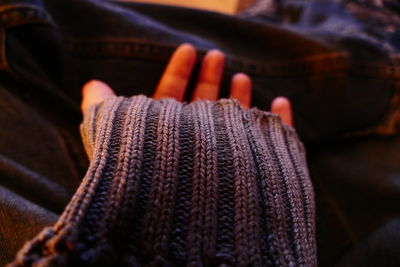 Cropped image of person wearing woolen sweater