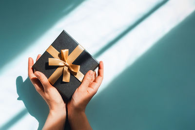 Gift box with a surprise inside on a blue background in the sunlight.