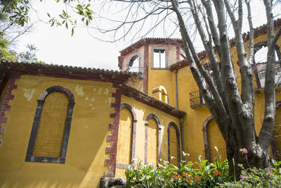 Low angle view of yellow building against sky