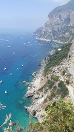 High angle view of sea and mountains against sky