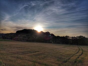 Scenic view of field against sky during sunset
