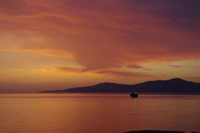 Scenic view of sea against orange sky