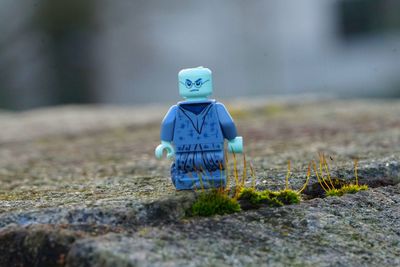 Rear view of boy sitting on field