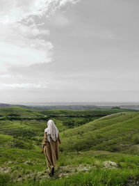 Rear view of man looking at landscape