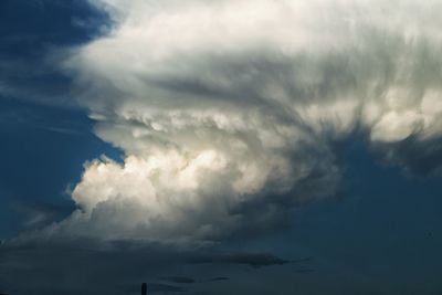 Low angle view of sea against cloudy sky