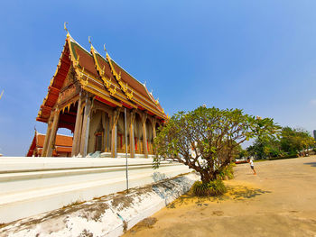 Low angle view of temple building against clear blue sky