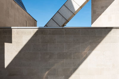 Minimalist photo of geometric shapes created by sunlight, shadows and parts of a building.