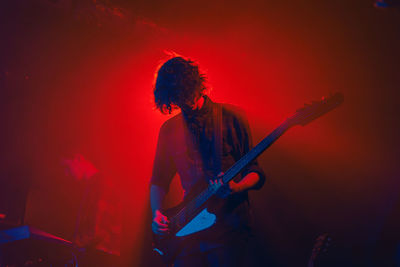 Man playing guitar again red light