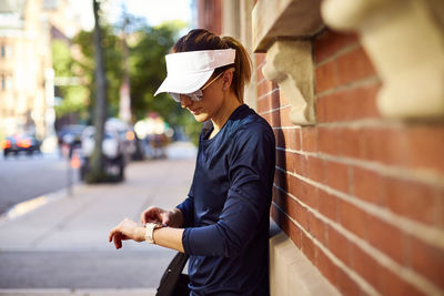 An athletic woman checking her fitness watch.