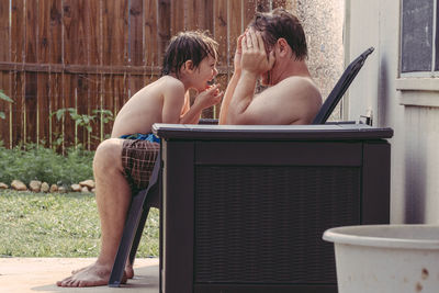 Rear view of men sitting outdoors