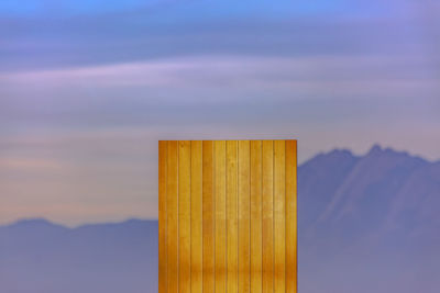 Close-up of wooden post against sky during sunset