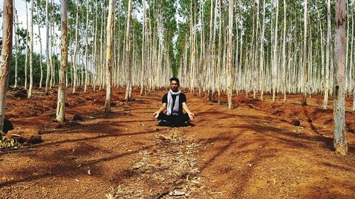 Man meditating amidst trees