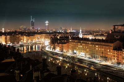 High angle view of city lit up at night