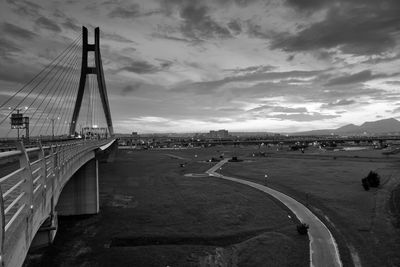 View of suspension bridge against cloudy sky