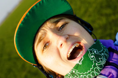 Portrait young woman smiling outside. confident female activist protesting outdoors. woman in green