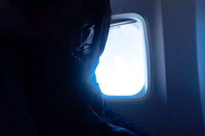 Woman sitting in airplane window