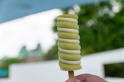 Close-up of hand holding ice cream cone