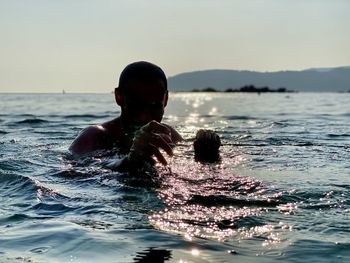 Woman swimming in sea