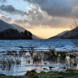 Scenic view of lake against cloudy sky