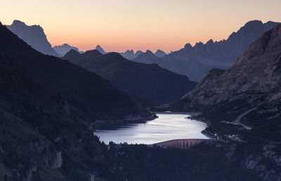 Scenic view of river amidst mountains against clear sky