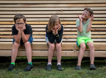 Portrait of three brothers sitting on bench