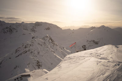 Rear view of people walking on snow covered mountain