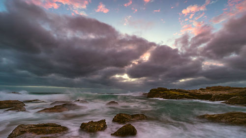 Scenic view of sea against cloudy sky