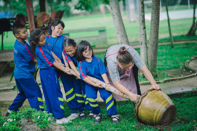 Rear view of people and daughter on plants