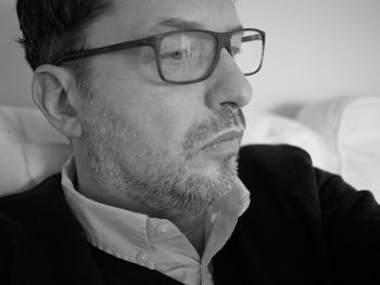 Portrait of man wearing eyeglasses at home