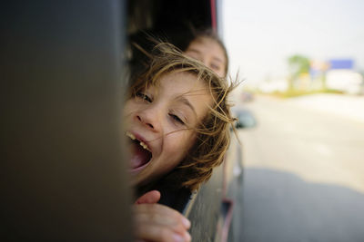 Cheerful leaning on vehicle window