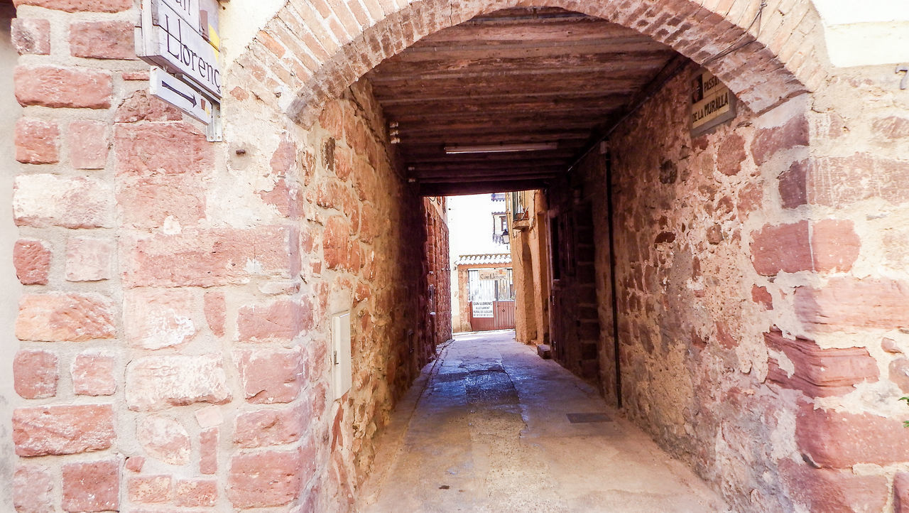 VIEW OF NARROW CORRIDOR ALONG WALLS