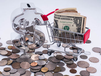 Close-up of coins on floor against white background