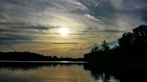 Scenic view of lake against cloudy sky