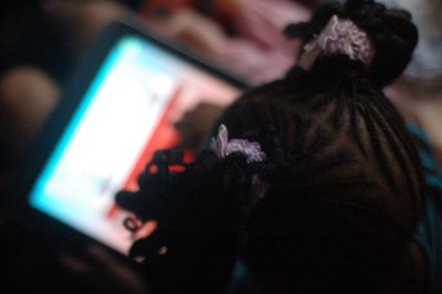 High angle view of girl using digital tablet in bedroom