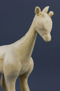 Close-up of wood giraffe against black background