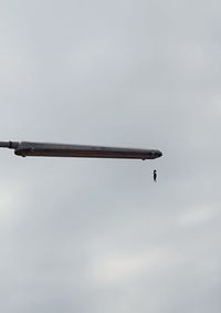 Low angle view of airplane flying against sky