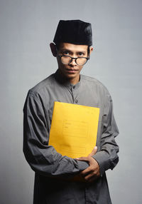 Portrait of young teacher against white background