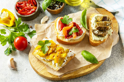 Open sandwiches set with salted salmon, sun dried tomato, grill aubergine, grill bulgarian pepper. 